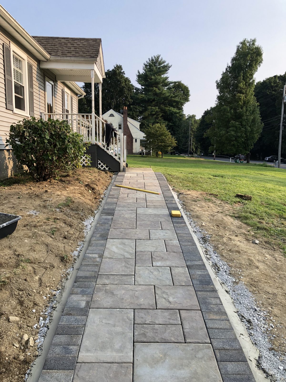 Paver walkway cutting across a lawn to a side entry, Dutchess County NY