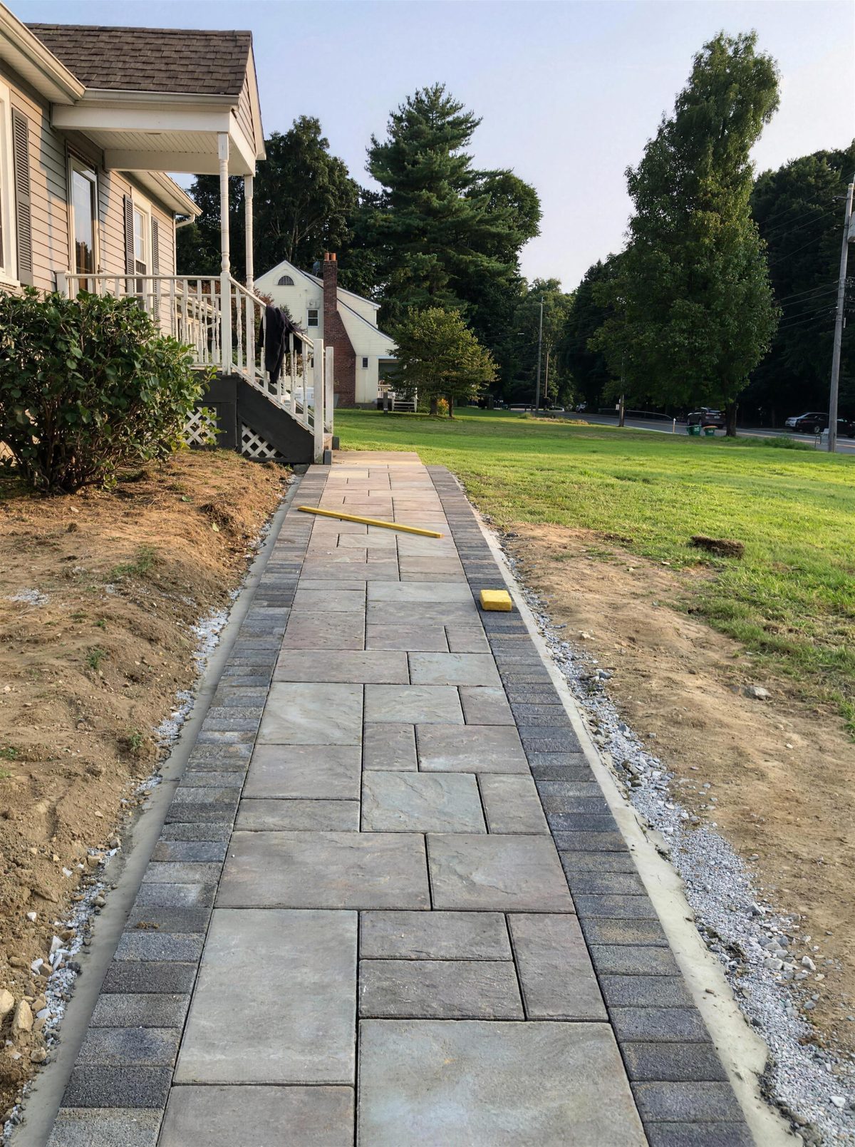 Long paver walkway with plantings along a residential front yard, Dutchess County NY